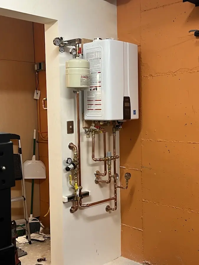 Plumbing technician inspecting water heater connections in Peachtree Corners